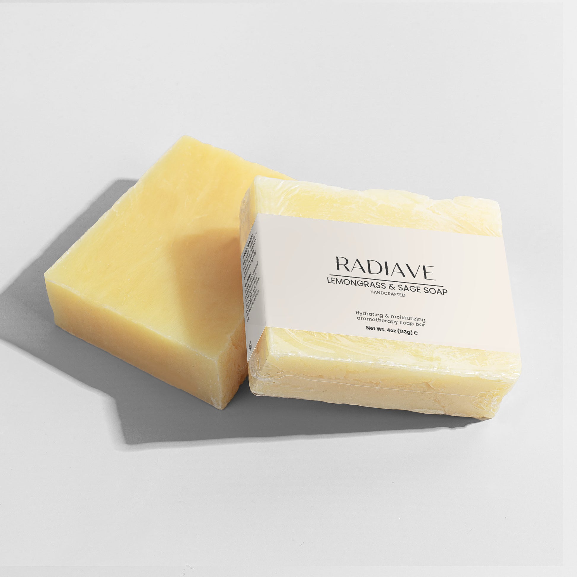 Two bars of Radiave lemongrass & sage soap on a light gray background