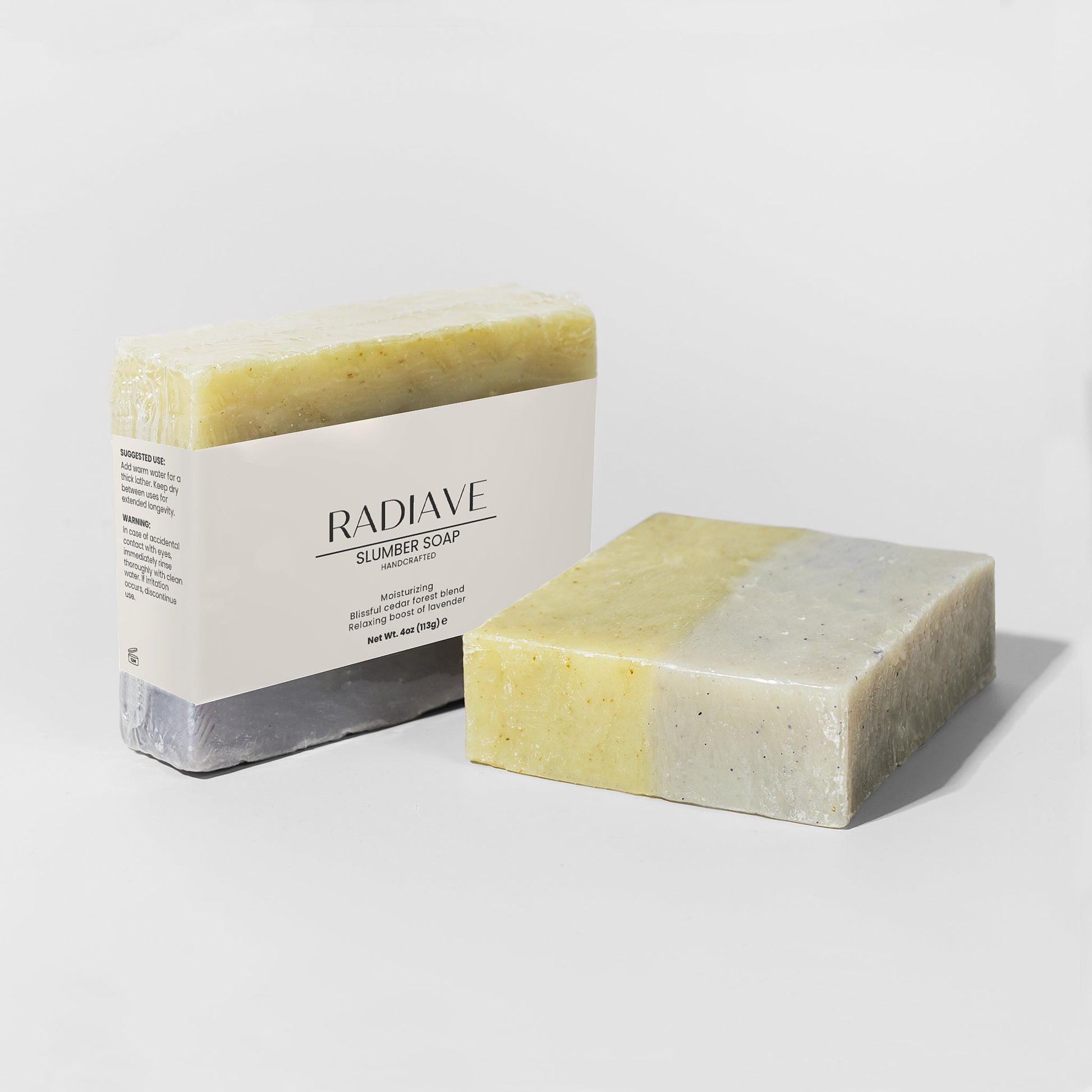 Two bars of soap, one with a visible brand label, on a light gray background